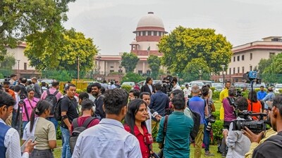 Media personnel stand outside the Supreme Court as the Constitution bench reads out its verdict on same-sex marriages, in New Delhi on Tuesday. (ANI)