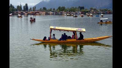 Tourists enjoy Shikara ride on the waters of Dal lake, in Srinagar on Tuesday. As the weather improved in Jammu and Kashmir on Wednesday, the Srinagar-Jammu highway was thrown open for traffic besides the opening of Mughal Road and Srinagar-Sonamarg-Gumri (SSG) road. (ANI)