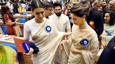 It was all friendship and warmth at the ceremony as both Alia Bhatt and Kriti Sanon won the Best Actress award. While Alia won for Gangubai Kathiawadi, Kriti won for Mimi. Allu Arjun is also seen in the frame. (Hindustan Times) It was all friendship and warmth at the ceremony as both Alia Bhatt and Kriti Sanon won the Best Actress award. While Alia won for Gangubai Kathiawadi, Kriti won for Mimi. Allu Arjun is also seen in the frame. (Hindustan Times)