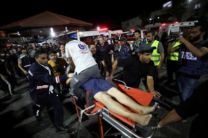 SENSITIVE MATERIAL. THIS IMAGE MAY OFFEND OR DISTURB   An injured person is assisted at Shifa Hospital after hundreds of Palestinians were killed in a blast at Al-Ahli hospital in Gaza that Israeli and Palestinian officials blamed on each other, in Gaza City, Gaza Strip, October 17, 2023. REUTERS/Mohammed Al-Masri (REUTERS)