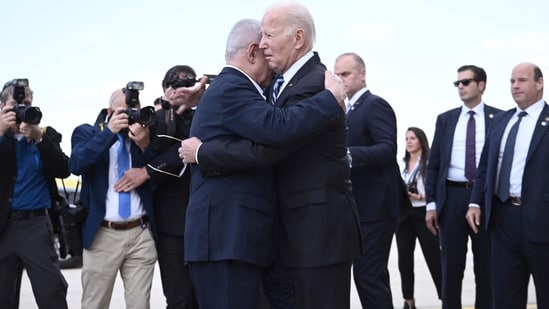 Israeli Prime Minister Benjamin Netanyahu and President Isaac Herzog met Biden at Ben Gurion Airport and hugged him.&nbsp;(AFP)