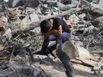 Israel-Hamas War: A Palestinian boy sits on the rubble of the building destroyed in an Israeli airstrike in Bureij refugee camp Gaza Strip. Israel-Hamas War: A Palestinian boy sits on the rubble of the building destroyed in an Israeli airstrike in Bureij refugee camp Gaza Strip.