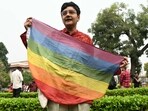 An activist holds a rainbow flag, a symbol of LGBT pride and LGBT social movements, in the courtyard of India's Supreme Court in New Delhi. (AFP)
