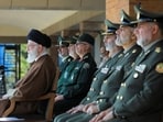 Iran's Supreme Leader Ayatollah Ali Khamenei (wearing brown)