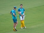 Australia's captain Pat Cummins talks to coach Andrew McDonald during a practice session.