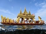 Devotees row the golden barge carrying the four sacred Buddha images during the festival of Phaung Daw Oo Pagoda in Inle Lake, Myanmar's Shan State, on October 19, 2023. Thousands of Buddhist devotees joined a waterborne procession on Myanmar's Inle lake as one of the country's biggest festivals returned to joy and sorrow as conflict between the military and its opponents rages on. 