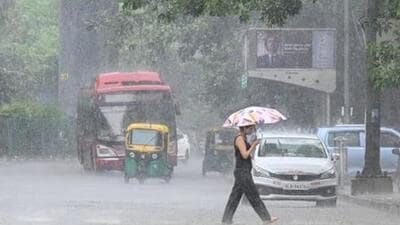 Commuters seen during heavy rains in New Delhi (Representative Photo) Commuters seen during heavy rains in New Delhi (Representative Photo)