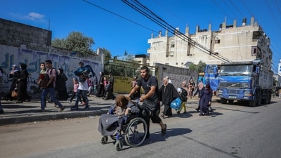 Palestinians flee on foot from Gaza City to southern Gaza after being told to leave their homes in the north by the Israeli military in the Gaza Strip on October 13. (Bloomberg) Palestinians flee on foot from Gaza City to southern Gaza after being told to leave their homes in the north by the Israeli military in the Gaza Strip on October 13. (Bloomberg)