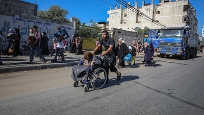 Palestinians flee on foot from Gaza City to southern Gaza after being told to leave their homes in the north by the Israeli military in the Gaza Strip on October 13. (Bloomberg) Palestinians flee on foot from Gaza City to southern Gaza after being told to leave their homes in the north by the Israeli military in the Gaza Strip on October 13. (Bloomberg)