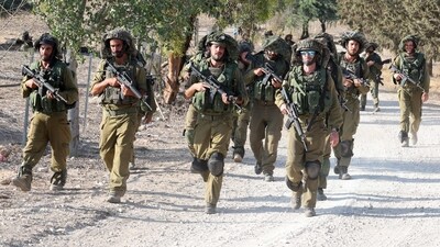 Israeli troops patrol at an undisclosed location along the border with the Gaza Strip (AFP) Israeli troops patrol at an undisclosed location along the border with the Gaza Strip (AFP)