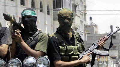 Palestinian militants from Hamas ride on a truck with their weapons in 2007. (AP) Palestinian militants from Hamas ride on a truck with their weapons in 2007. (AP)