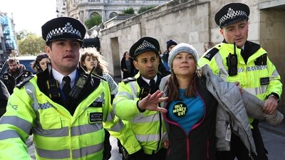 Swedish climate activist Greta Thunberg is arrested outside the InterContinental London Park Lane during the "Oily Money Out" demonstration organised by Fossil Free London and Greenpeace. (AFP) Swedish climate activist Greta Thunberg is arrested outside the InterContinental London Park Lane during the "Oily Money Out" demonstration organised by Fossil Free London and Greenpeace. (AFP)