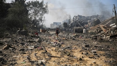 Palestinians boy walks by the buildings destroyed in the Israeli bombardment on al-Zahra, on the outskirts of Gaza City. (AP) Palestinians boy walks by the buildings destroyed in the Israeli bombardment on al-Zahra, on the outskirts of Gaza City. (AP)