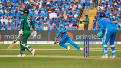 Ravindra Jadeja, center, fields a ball plays a shot during the ICC Men's Cricket World Cup match between India and Bangladesh in Pune (AP)