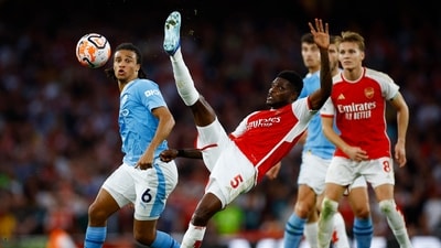 Manchester City's Nathan Ake in action with Arsenal's Thomas Partey (Action Images via Reuters)