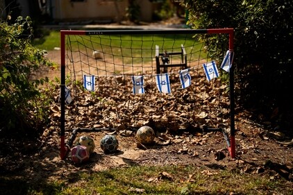 Israel flags hang in a soccer goal in a backyard of a home that came under attack during a massive Hamas invasion into Kibbutz Nir Oz. (AP) Israel flags hang in a soccer goal in a backyard of a home that came under attack during a massive Hamas invasion into Kibbutz Nir Oz. (AP)