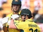 David Warner (R) speaks with Mitchell Marsh during the 2023 ICC Men's Cricket World Cup one-day international (ODI) match between Australia and Pakistan.