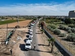 This aerial view shows humanitarian aid trucks arriving from Egypt after having crossed through the Rafah border crossing. This aerial view shows humanitarian aid trucks arriving from Egypt after having crossed through the Rafah border crossing.