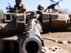 Israeli soldiers sit on a Merkava tank as they man a position at an undisclosed location on the border with Lebanon. (AFP) Israeli soldiers sit on a Merkava tank as they man a position at an undisclosed location on the border with Lebanon. (AFP)