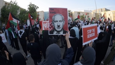 Bahrainis carry placards during a gathering in Manama on October 20, 2023, to express their solidarity with the Palestinian people. (AFP)
