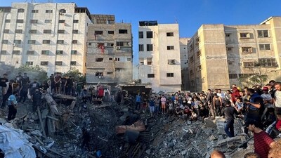 Palestinians gather at the site of an Israeli strike on a house, amid the ongoing conflict between Israel and Hamas. (REUTERS)