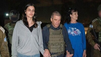 Judith Raanan, right, and her 17-year-old daughter Natalie are escorted by Israeli soldiers and Gal Hirsch, Prime Minister Benjamin Netanyahu's special coordinator for returning the hostages. (AP)
