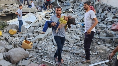 Palestinian carries a child killed in an airstrike on the buildings of Abu Asad family in Deir el-Balah, southern Gaza Strip, Saturday, Oct. 21, 2023. (AP Photo/Hassan Eslaiah) (AP) Palestinian carries a child killed in an airstrike on the buildings of Abu Asad family in Deir el-Balah, southern Gaza Strip, Saturday, Oct. 21, 2023. (AP Photo/Hassan Eslaiah) (AP)