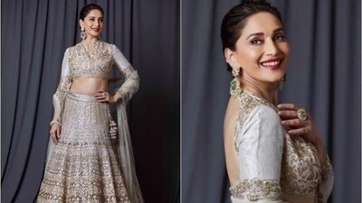 Madhuri Dixit's grey and gold lehenga is the epitome of glamour and elegance. Her heavily embellished and embroidered lehenga attire features a V-neck blouse with full sleeves and gold work detailing. The flared lehenga skirt embellished with intricate gold sequin embroidery all over is enough to make anyone swoon. Paired with a net duppata and traditional Indian jewellery, she looked like the ultimate queen. (Instagram/@madhuridixitnene)