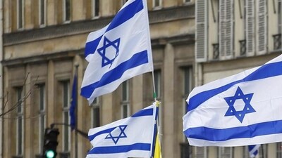 Close-up shot of Israeli flags being waved by people during a rally. (AP File Photo)