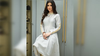 Mouni Roy's gorgeous grey gotapatti suit with bandh gala, full sleeves, fitted bodice and flared bottom is perfect for those who like to keep things minimal. Pair it with a straight fitted trouser or even a sharara skirt for the ultimate festive look. With smudged eyeliner, mascaraed lashes, contoured cheeks, nude lipstick and an open middle parted hairdo, you are ready to turn heads. (Instagram/@imouniroy)