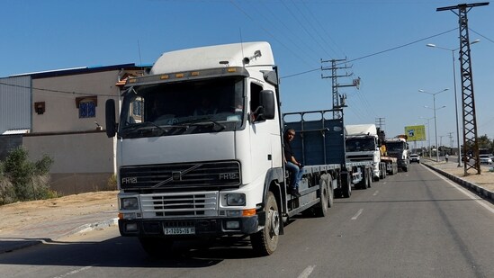 Trucks loaded with aid that will be delivered to Palestinians in Gaza, enters Rafah in the southern Gaza Strip October 21, 2023.