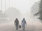 Commuters out on a smoggy morning amid rising air pollution levels
