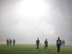 New Zealand's Tom Latham and Trent Boult walk off as play is stopped due to bad weather