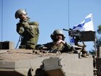 Israeli soldiers sit on a Merkava tank as they man a position at an undisclosed location on the border with Lebanon Israeli soldiers sit on a Merkava tank as they man a position at an undisclosed location on the border with Lebanon