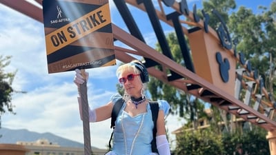 Andrea Calabrese carries a sign on the picket line outside Walt Disney Studios. (AP) Andrea Calabrese carries a sign on the picket line outside Walt Disney Studios. (AP)