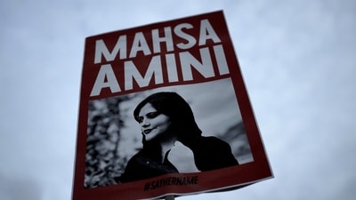 Iran Anti-Hijab Protests: A woman holds a placard with a picture of Iranian woman Mahsa Amini during a protest against her death. (AP) Iran Anti-Hijab Protests: A woman holds a placard with a picture of Iranian woman Mahsa Amini during a protest against her death. (AP)