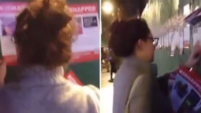 A woman in Brooklyn was caught on camera tearing down posters of Israeli hostages kidnapped by Hamas terrorists (r/williamsburg/Reddit) A woman in Brooklyn was caught on camera tearing down posters of Israeli hostages kidnapped by Hamas terrorists (r/williamsburg/Reddit)