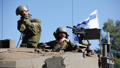 Israeli soldiers sit on a Merkava tank as they man a position at an undisclosed location on the border with Lebanon (AFP) Israeli soldiers sit on a Merkava tank as they man a position at an undisclosed location on the border with Lebanon (AFP)