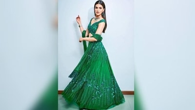 Kriti Sanon's emerald peacock green lehenga is the perfect outfit inspiration for day 9 of Navratri. Featuring intricate tone-on-tone beading and sequins, the A-line design and 3D floral embellishments on the voluminous skirt make her look absolutely stunning. The plunging neckline of her off-the-shoulder blouse and the beaded tassels on her dupatta give a modern twist to the ethnic look. (Instagram/@KritiSanon)
