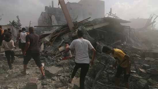 Israel-Hamas War: Palestinians look for survivors in buildings destroyed in the Israeli bombardment of the Gaza Strip in Rafah. (AP)