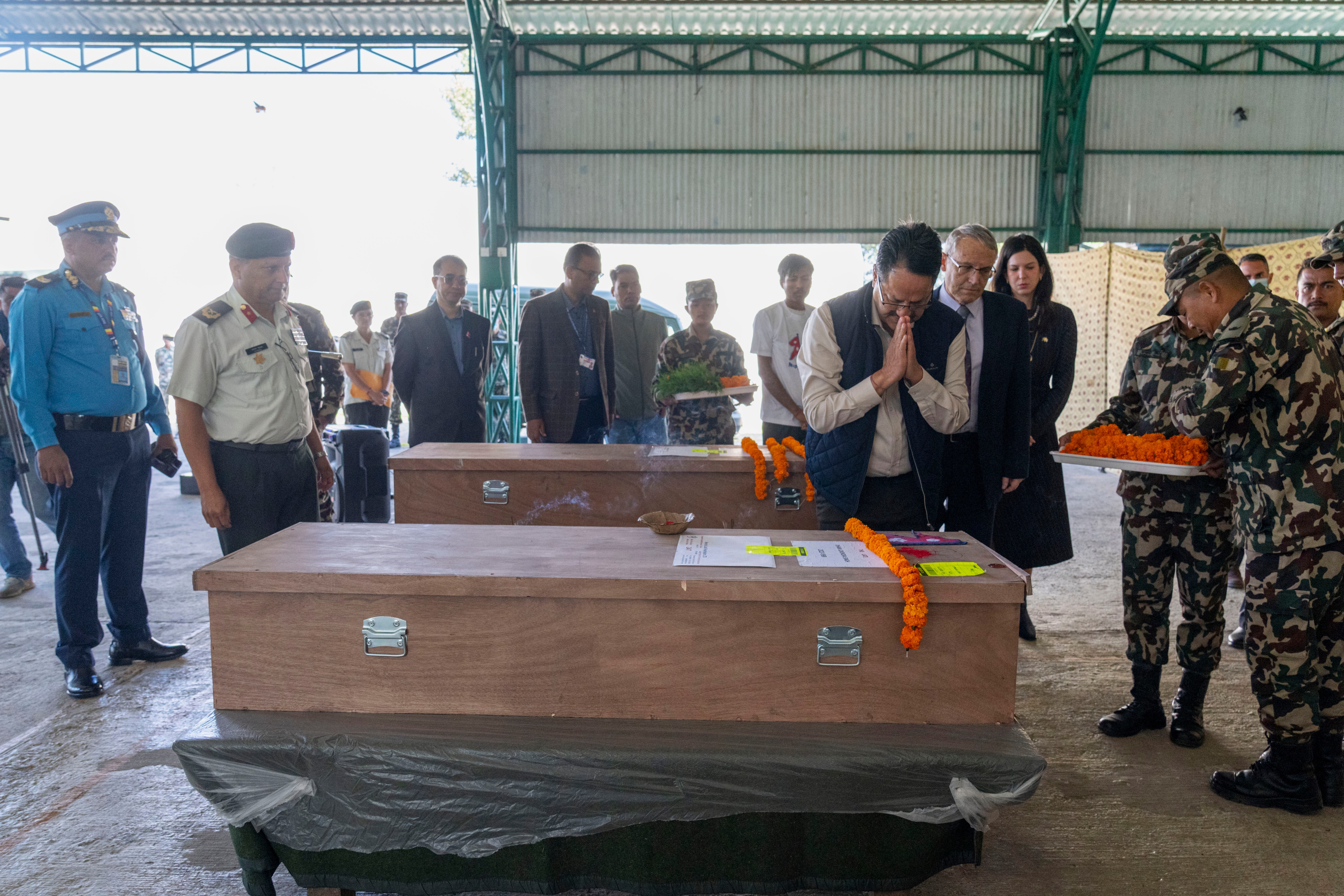 Nepalese Foreign Minister Narayan Prassad Saud pays his respect to Nepali nationals who were killed by the Hamas attack in Israel as their coffins arrive at Tribhuvan International Airport in Kathmandu, Nepal, Sunday, Oct. 22, 2023.  (AP)