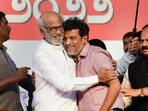 Actors Rajinikanth hugs actor Shiva Rajkumar during a ceremony for the Karnataka Ratna Award presentation. Actors Rajinikanth hugs actor Shiva Rajkumar during a ceremony for the Karnataka Ratna Award presentation.