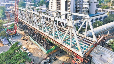 “The girder will be first pushed 100 metres to the other side, from above the railway tracks. It will then be pushed to the north about 13.5 metres and will be brought down on the pillar at 7.5 metres below.” BMC said in the press note (HT PHOTO) “The girder will be first pushed 100 metres to the other side, from above the railway tracks. It will then be pushed to the north about 13.5 metres and will be brought down on the pillar at 7.5 metres below.” BMC said in the press note (HT PHOTO)