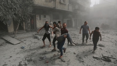 Israel-Hamas War: Palestinians evacuate a wounded man following Israeli airstrikes on Gaza City. (AP) Israel-Hamas War: Palestinians evacuate a wounded man following Israeli airstrikes on Gaza City. (AP)