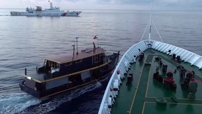 A Philippine flagged boat is blocked by a China Coast Guard vessel during an incident that resulted in a collision between the two vessel. (Reuters)