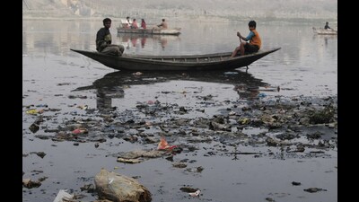 Garbage - Water Pollution - TOURIST TAKING BOAT RIDE ON RIVER GOMTI WITH DIRT ALL AROUND HERE ON SUNDAY. PHOTO BY DHEERAJ DHAWAN/HT (File)