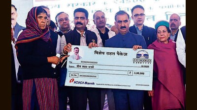 Himachal chief minister Sukhvinder Singh Sukhu hands over a cheque for ₹3 lakh to members of a flood-hit family, in Mandi on Monday. (Birbal Sharma/HT) Himachal chief minister Sukhvinder Singh Sukhu hands over a cheque for ₹3 lakh to members of a flood-hit family, in Mandi on Monday. (Birbal Sharma/HT)
