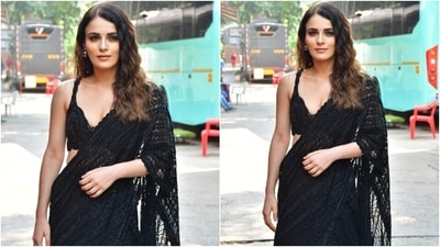 Radhika Madan slipped into a black embellished lehenga set for the promotional event. While the blouse features a plunging V neckline, thin shoulder straps, sequin work, beaded embroidery, and scalloped trims, the lehenga has a high-rise waist, floor-grazing hem, pleated layered ghera, and an A-line silhouette. She draped the net-embroidered dupatta around her body like a saree pallu. (HT Photo/Varinder Chawla) Radhika Madan slipped into a black embellished lehenga set for the promotional event. While the blouse features a plunging V neckline, thin shoulder straps, sequin work, beaded embroidery, and scalloped trims, the lehenga has a high-rise waist, floor-grazing hem, pleated layered ghera, and an A-line silhouette. She draped the net-embroidered dupatta around her body like a saree pallu. (HT Photo/Varinder Chawla)