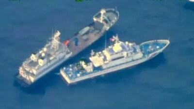 A Chinese militia vessel, top, near Philippine coast guard vessel BRP Cabra as they approach Second Thomas Shoal, locally called Ayungin Shoal, at the disputed South China Sea. (AP)