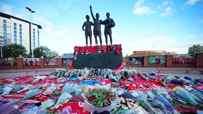 Floral tributes are pictured at the base of the 'United Trinity' sculpture, depicting former Manchester United players George Best, Denis Law and Bobby Charlton, outside Old Trafford. (AFP) Floral tributes are pictured at the base of the 'United Trinity' sculpture, depicting former Manchester United players George Best, Denis Law and Bobby Charlton, outside Old Trafford. (AFP)